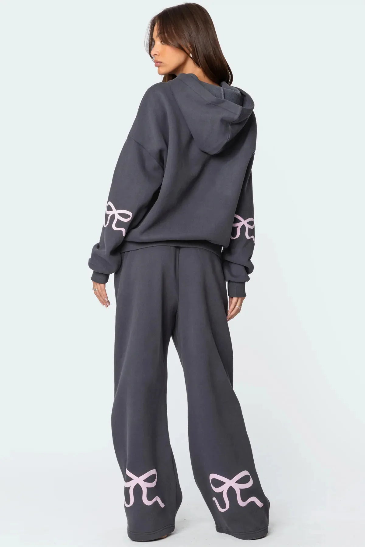 Träningsoverall med huva och rosettdesign