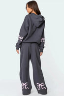 Träningsoverall med huva och rosettdesign