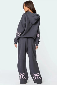 Träningsoverall med huva och rosettdesign