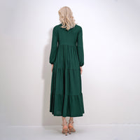 Ellenns mörkgrön långärmad klänning med volanger