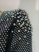 Svart smal tvådelad klänning med långa ärmar, paljetter och djup halsringning