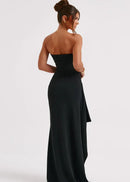 Axelbandslös svart klänning med djup rygg och djup slits i benet