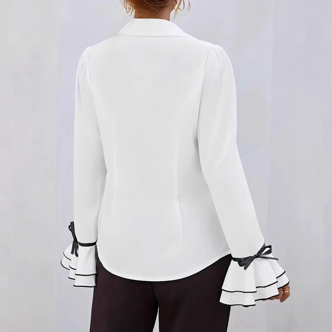 Avslappnad blus med utsvängda ärmar och vågig krage