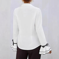 Avslappnad blus med utsvängda ärmar och vågig krage