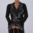 Avslappnad blus med utsvängda ärmar och vågig krage