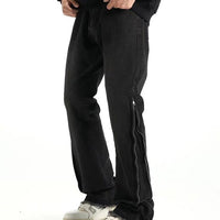 Svarta jeansbyxor med dragkedja nedtill