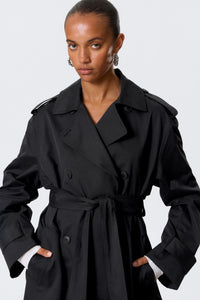 Svart trenchcoat med knappar och bälte