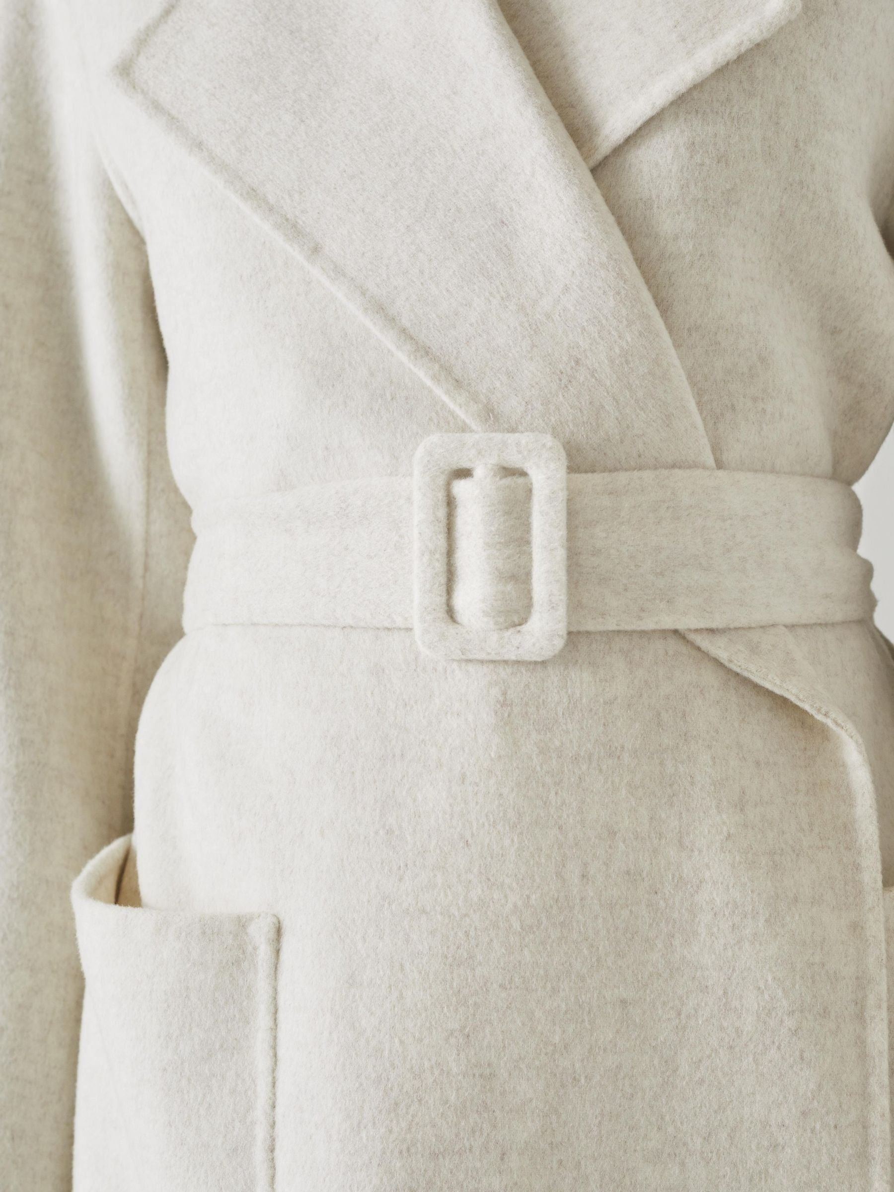 Ullkappa med dubbla rader knappar och skärp i midjan