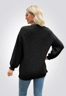 Svart stickad tröja med knappar framtill och långa ärmar