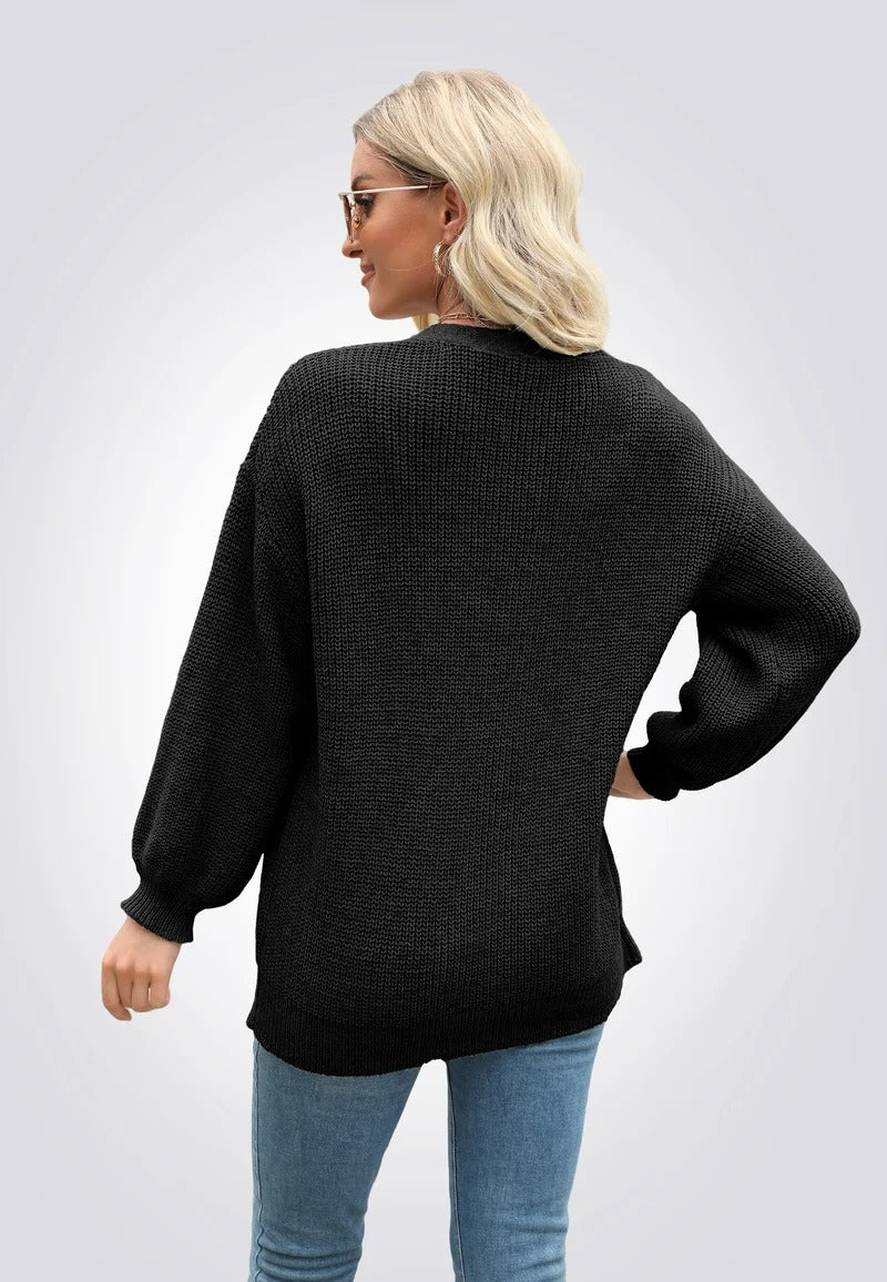 Svart stickad tröja med knappar framtill och långa ärmar