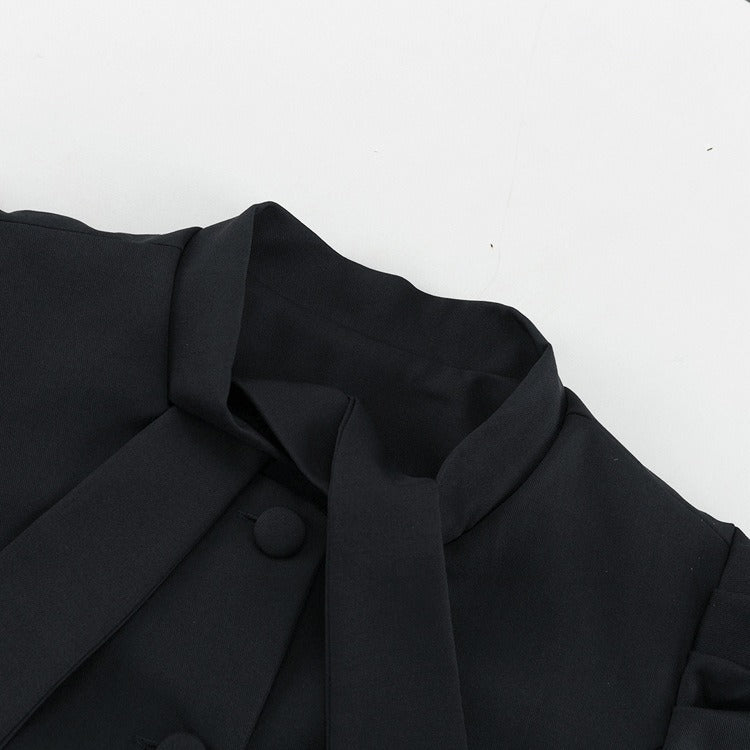 Grått tvådelat set med kjol, långa ärmar och fluga