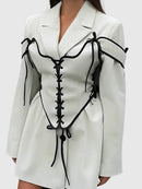 Långärmad jacka med knappar och korsett